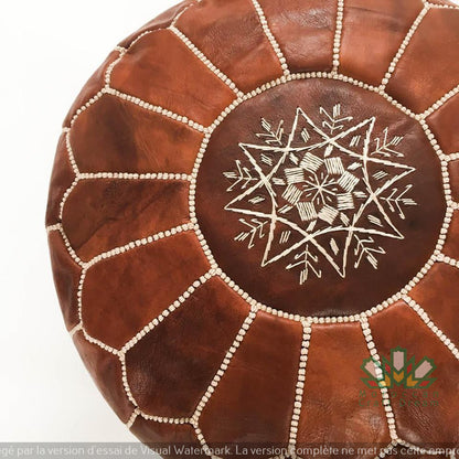 Round Moroccan leather poufs used as a coffee table, handcrafted with durable materials and traditional stitching in natural tones.