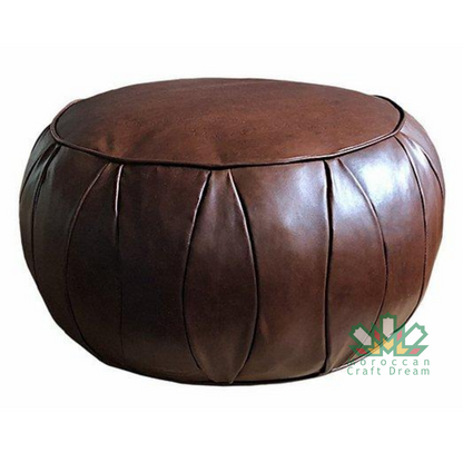 Chocolate Round leather moroccan pouf used as a coffee table, handcrafted with durable materials and traditional stitching in natural tones.