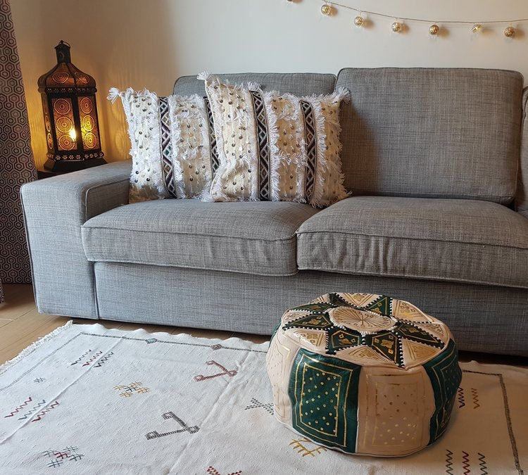 Handcrafted leather Moroccan pouf ottoman and footstool in natural tones featuring traditional stitching and soft durable materials.