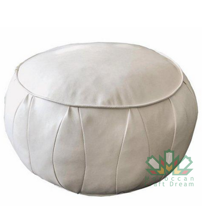 White handmade round Moroccan pouf ottoman in genuine leather, perfect for use as a versatile coffee table or footrest. This Moroccan leather ottoman enhances living room decor with its elegant design and multifunctional use. Crafted from high-quality lea