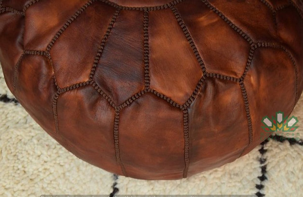 Authentic Moroccan brown tan leather pouf ottoman, handcrafted for use as a coffee table or footrest in any home decor.