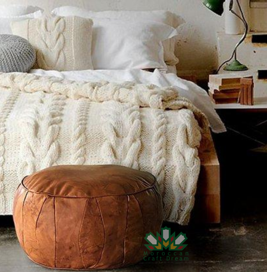 Tan Round leather moroccan pouf used as a coffee table, handcrafted with durable materials and traditional stitching in natural tones.